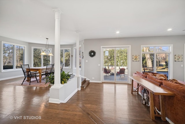 entrance foyer featuring recessed lighting, baseboards, dark wood-type flooring, and ornate columns