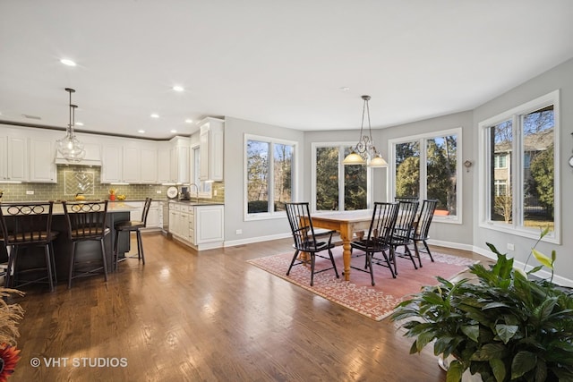 dining space with dark wood-type flooring, recessed lighting, and baseboards