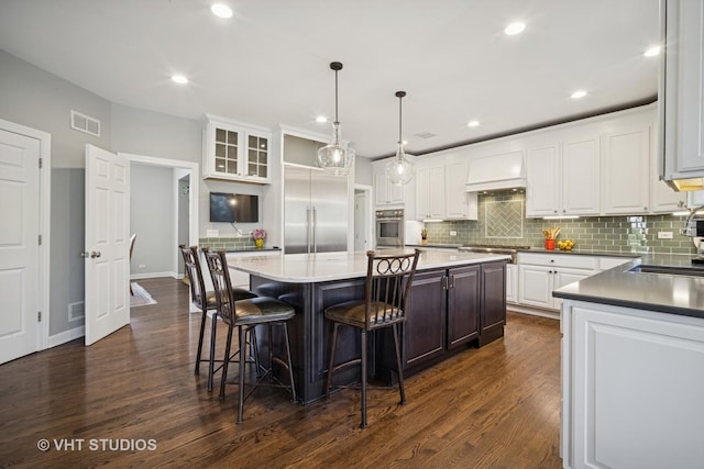 kitchen with white cabinetry, visible vents, appliances with stainless steel finishes, and a kitchen island