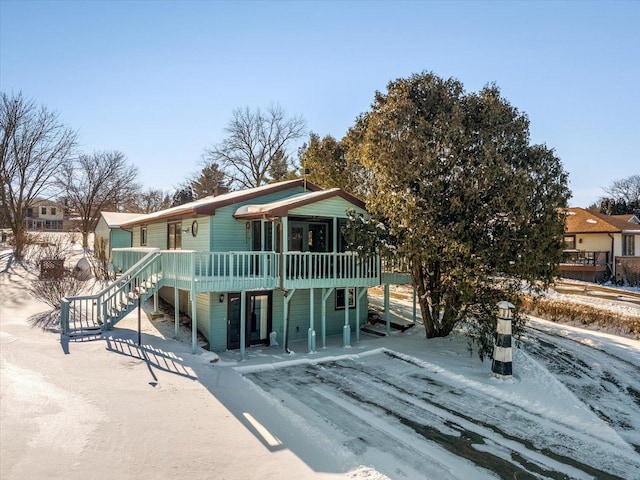 view of front of home featuring stairway and a wooden deck