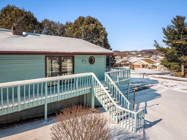 view of front of house featuring stairs, a chimney, and a deck