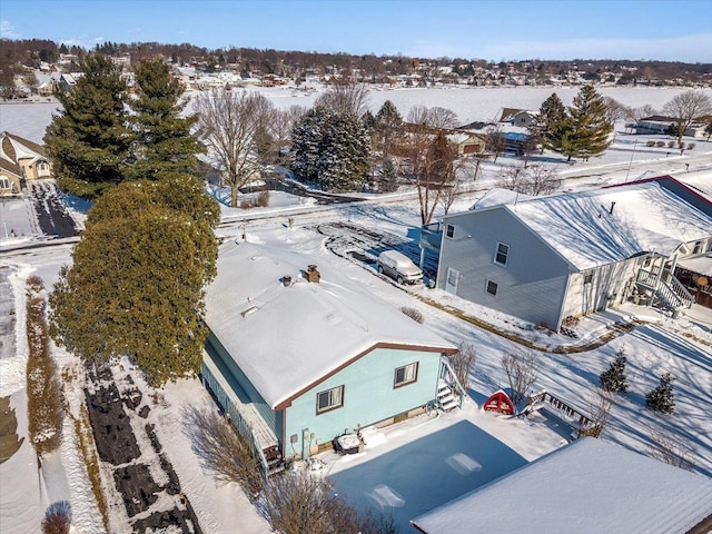 snowy aerial view with a residential view