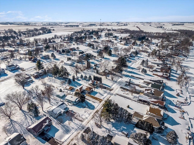 snowy aerial view with a residential view