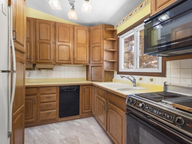 kitchen featuring open shelves, a sink, light countertops, black appliances, and brown cabinetry