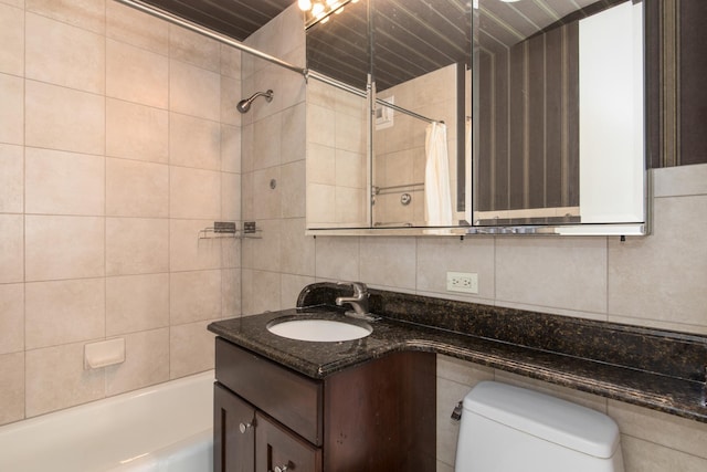 full bathroom with vanity, toilet, tile walls, and decorative backsplash