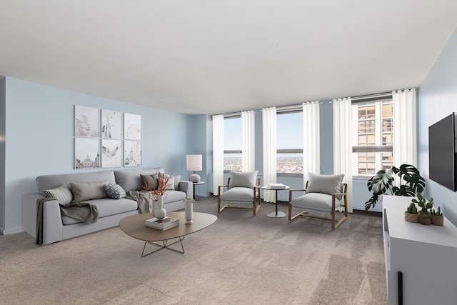 living room featuring light colored carpet and a healthy amount of sunlight