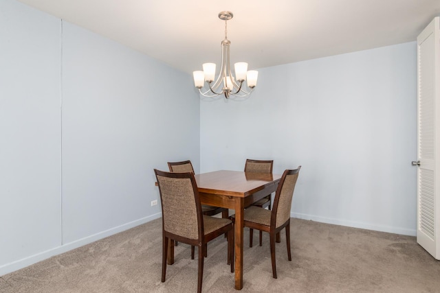 carpeted dining space featuring an inviting chandelier