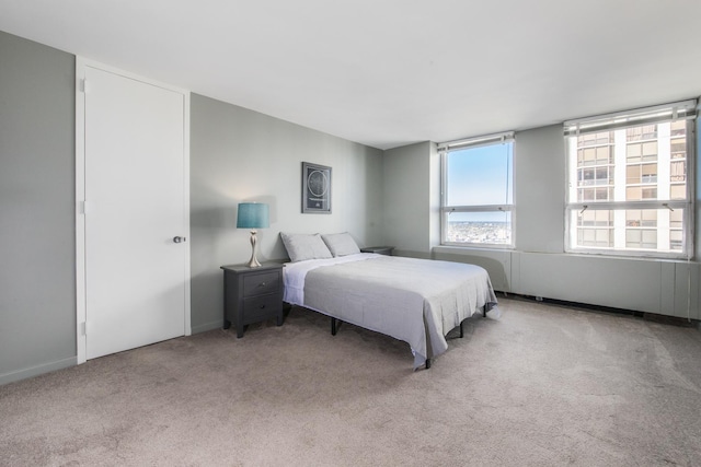 bedroom featuring light carpet