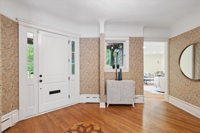 entrance foyer with light hardwood / wood-style floors and baseboard heating