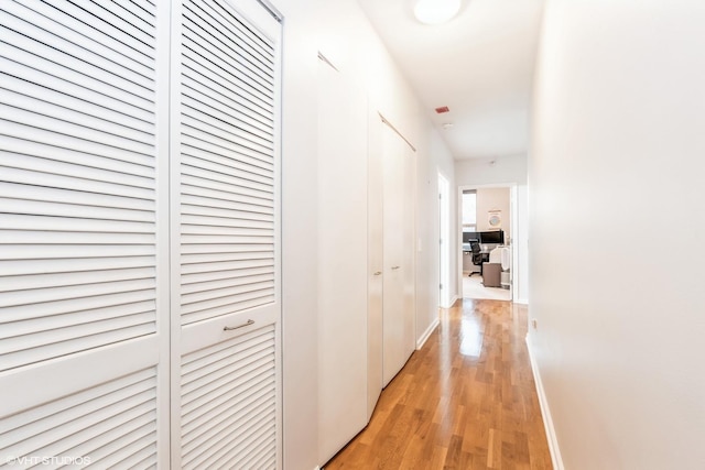 corridor with light hardwood / wood-style flooring