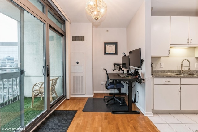 office space featuring sink and light hardwood / wood-style flooring