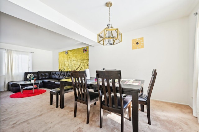 dining space with baseboards and light colored carpet