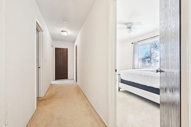 hallway with light colored carpet