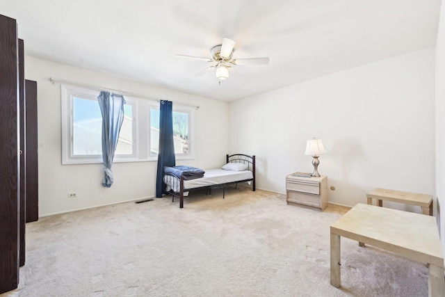 bedroom featuring light carpet, ceiling fan, and visible vents