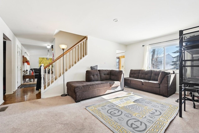 living area with carpet floors and stairway