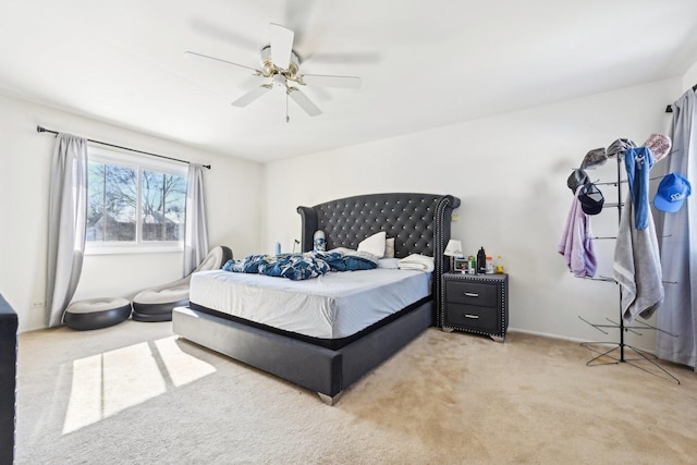 bedroom featuring a ceiling fan and light colored carpet