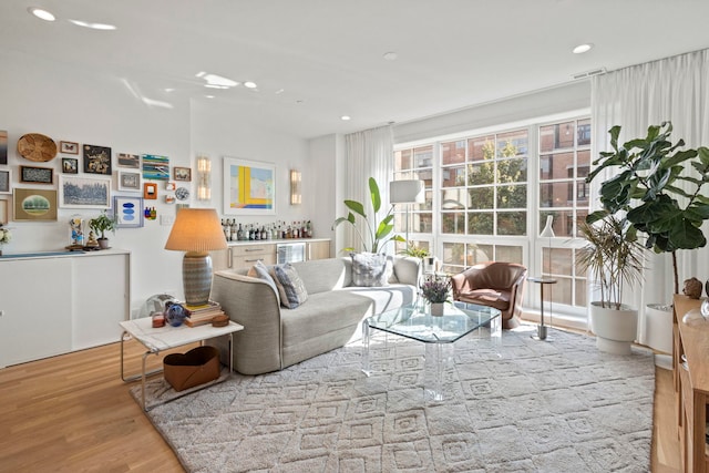 interior space with bar area and light wood-type flooring