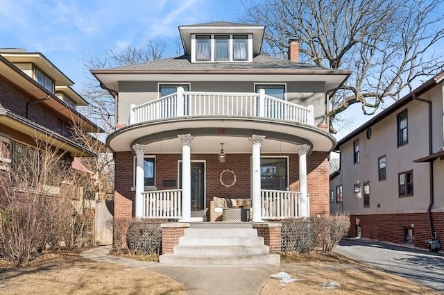 view of front of house featuring a balcony and covered porch