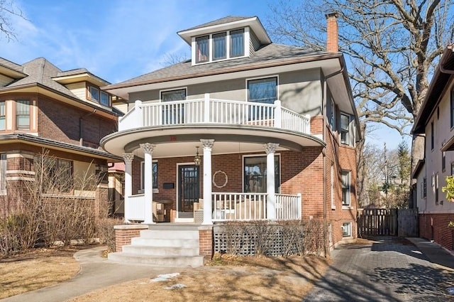 view of front of property featuring a balcony and covered porch