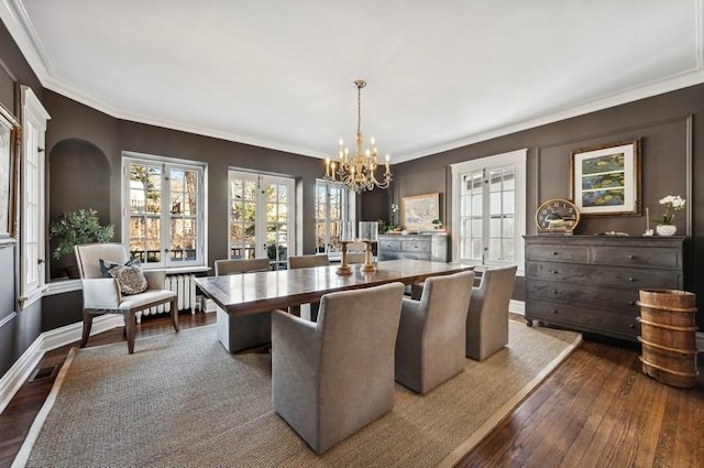 dining room with crown molding, dark wood-type flooring, and french doors