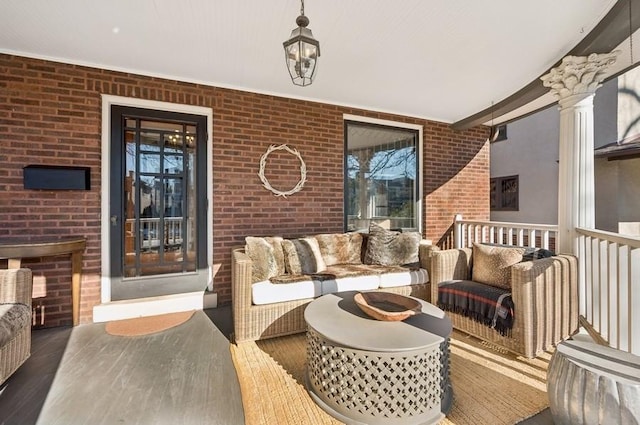 interior space with an outdoor hangout area and covered porch