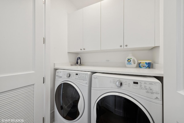 laundry area with cabinets and washing machine and dryer