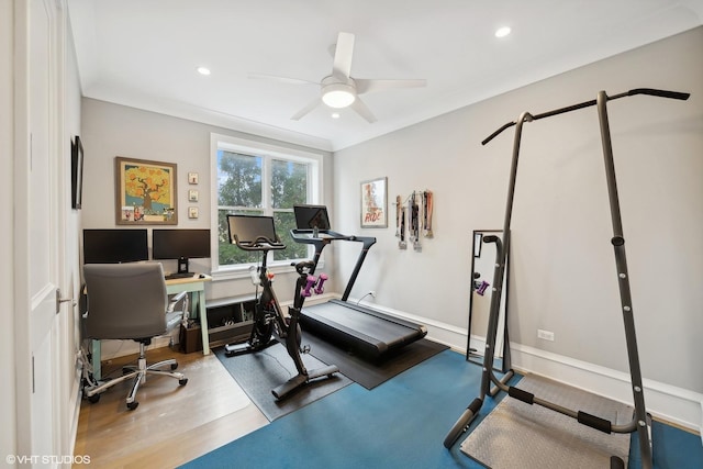 exercise room featuring hardwood / wood-style flooring, ceiling fan, and ornamental molding