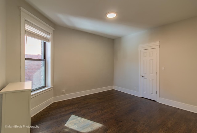 spare room with dark hardwood / wood-style floors