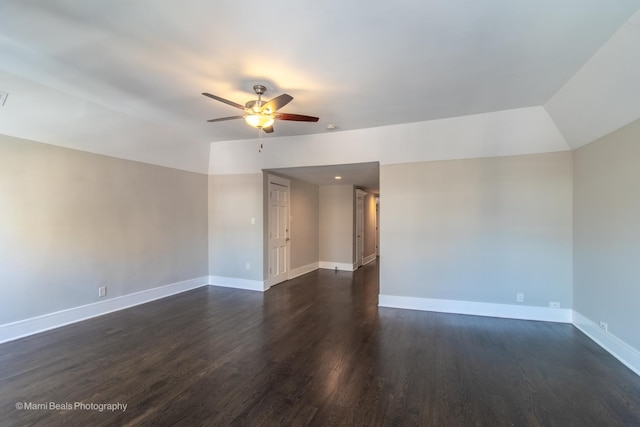 spare room featuring ceiling fan, lofted ceiling, and dark hardwood / wood-style flooring