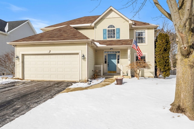 traditional home featuring a garage and aphalt driveway