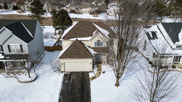 snowy aerial view featuring a residential view