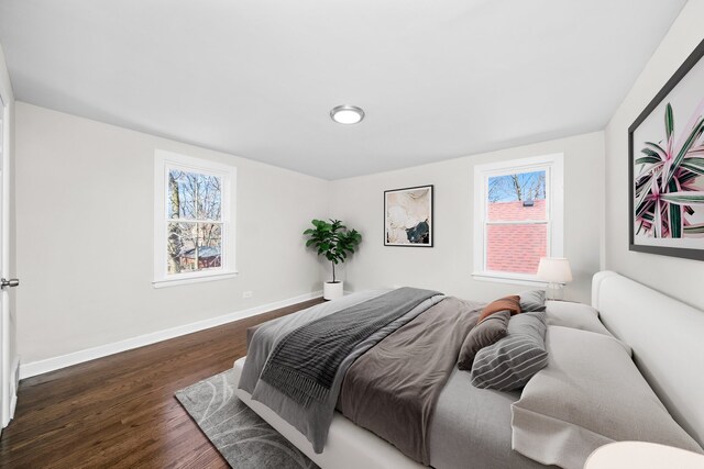 unfurnished room with baseboards and dark wood-style flooring