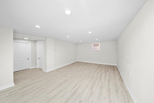 below grade area featuring recessed lighting, light wood-type flooring, and baseboards