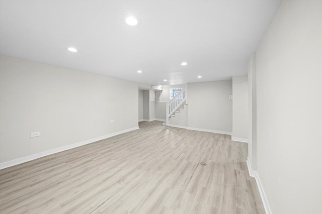 basement with stairway, recessed lighting, baseboards, and light wood-style floors