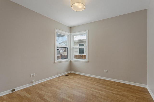 spare room featuring light wood-type flooring