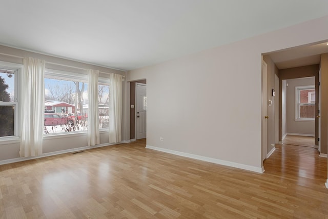 spare room featuring light hardwood / wood-style flooring