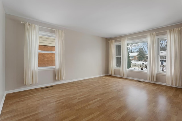 spare room with light hardwood / wood-style floors