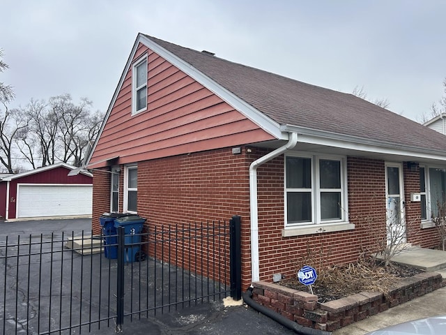 view of side of property featuring a garage and an outdoor structure