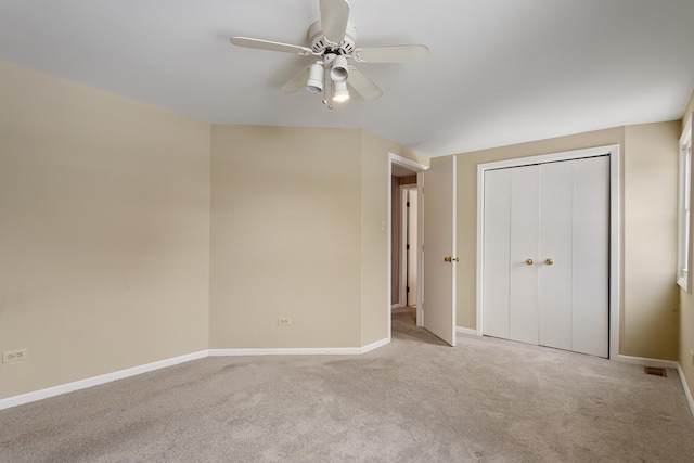 unfurnished bedroom with light carpet, ceiling fan, and a closet