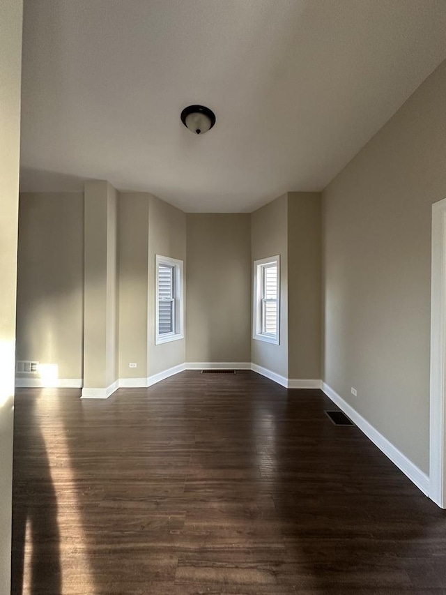 spare room with dark hardwood / wood-style floors