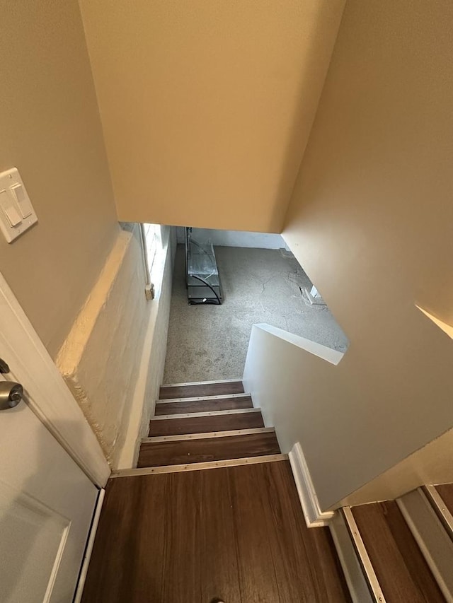 stairs featuring hardwood / wood-style floors