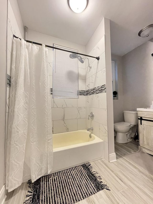 full bathroom featuring vanity, shower / tub combo, and toilet