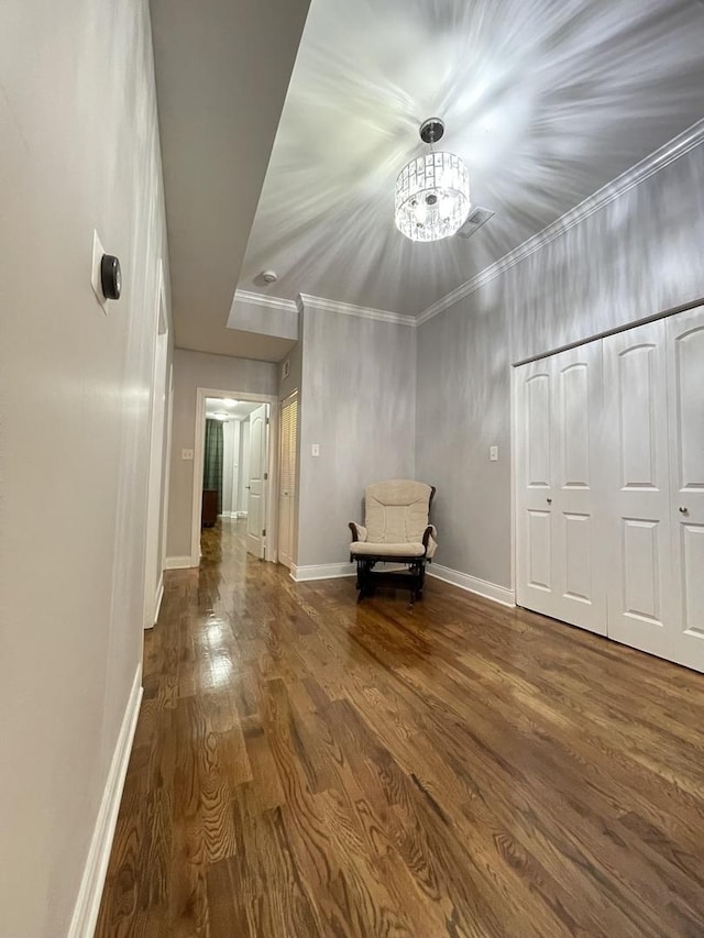 unfurnished room featuring dark wood-type flooring and ornamental molding