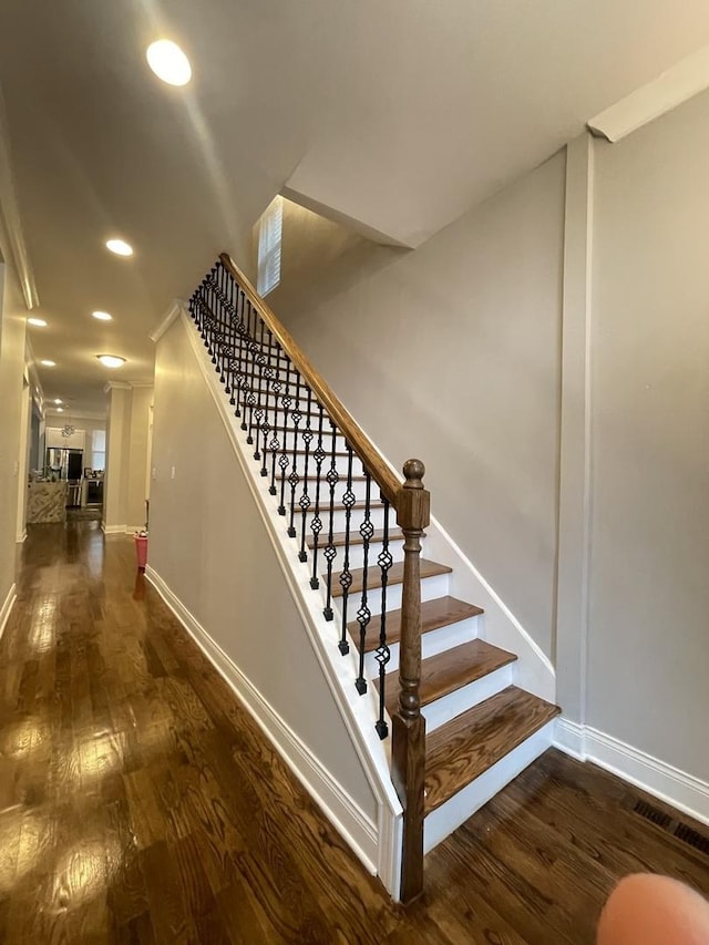 staircase with wood-type flooring