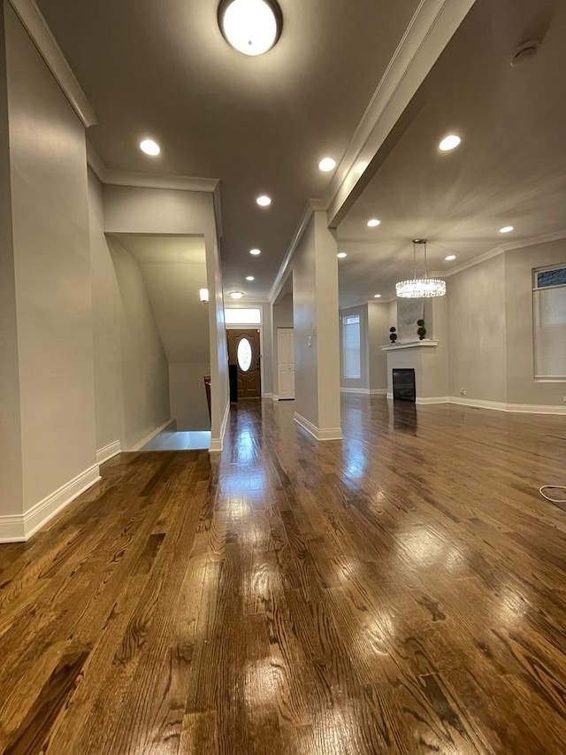 foyer entrance with dark wood-type flooring and ornamental molding