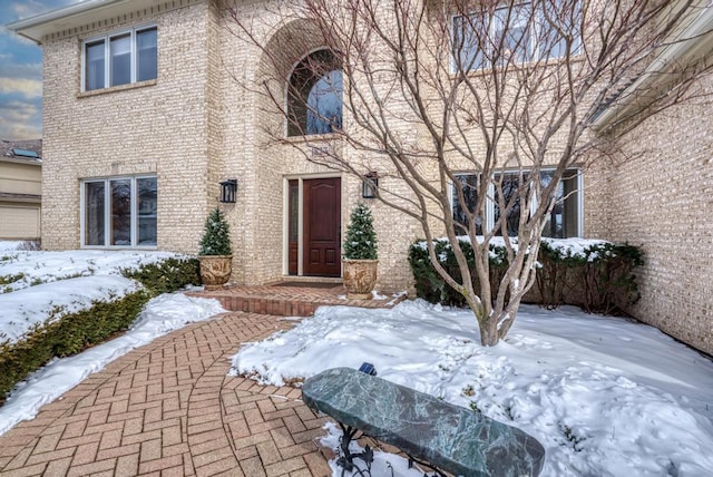 view of snow covered property entrance