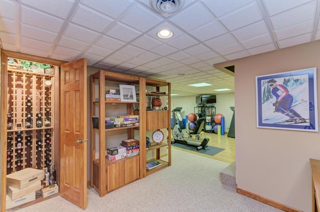 interior space featuring carpet and a paneled ceiling