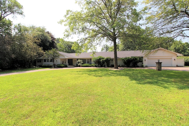 single story home featuring a garage and a front lawn