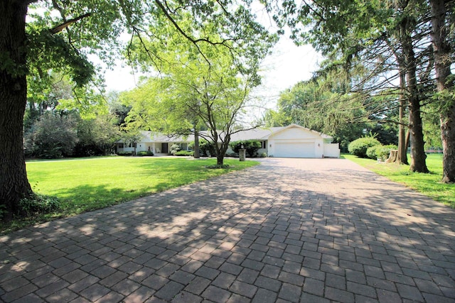 view of front of home featuring a garage and a front lawn