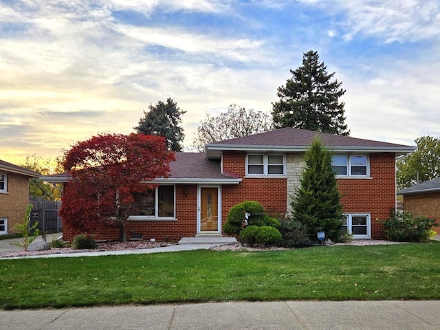 tri-level home featuring a yard